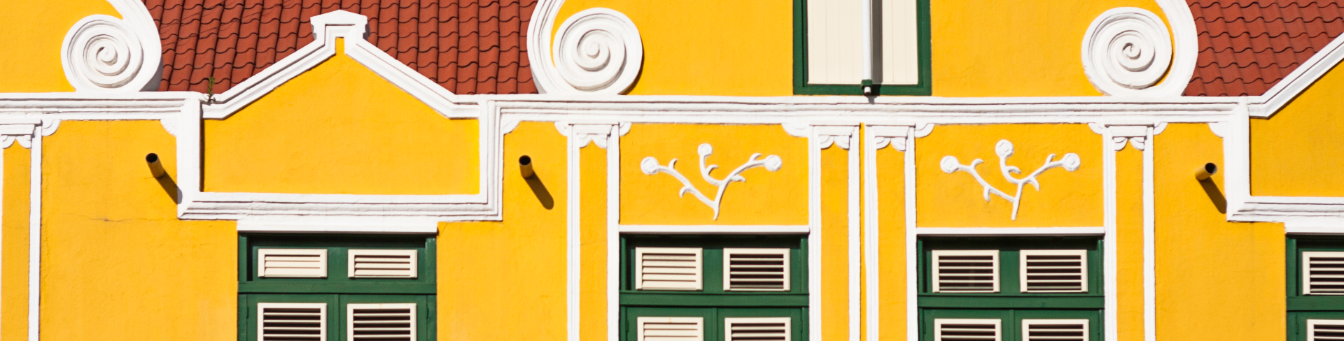 A stylized image of a house with typical postcolonial arches.