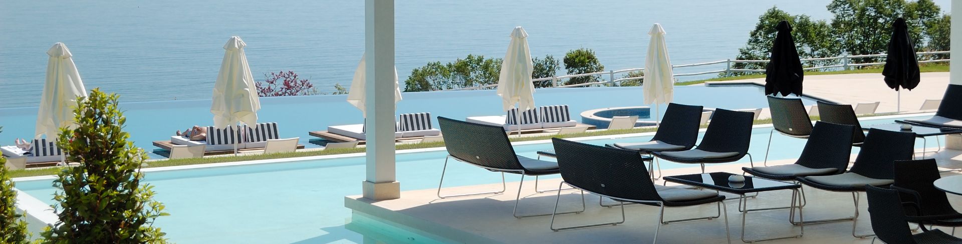 A cabana shields poolside chairs from the sun.