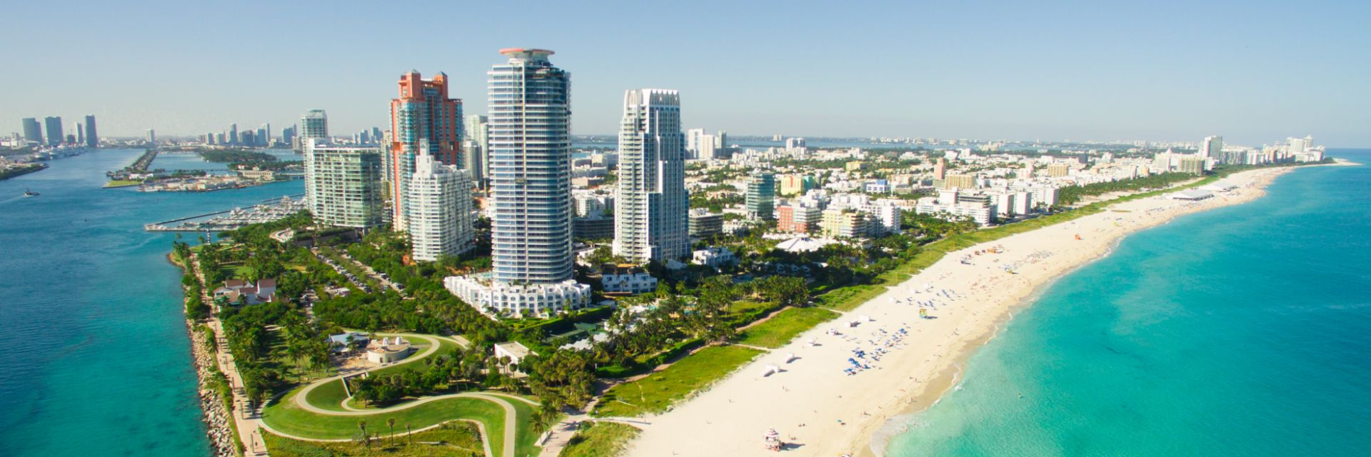 Miami's skyline peaks above teal blue ocean waters.