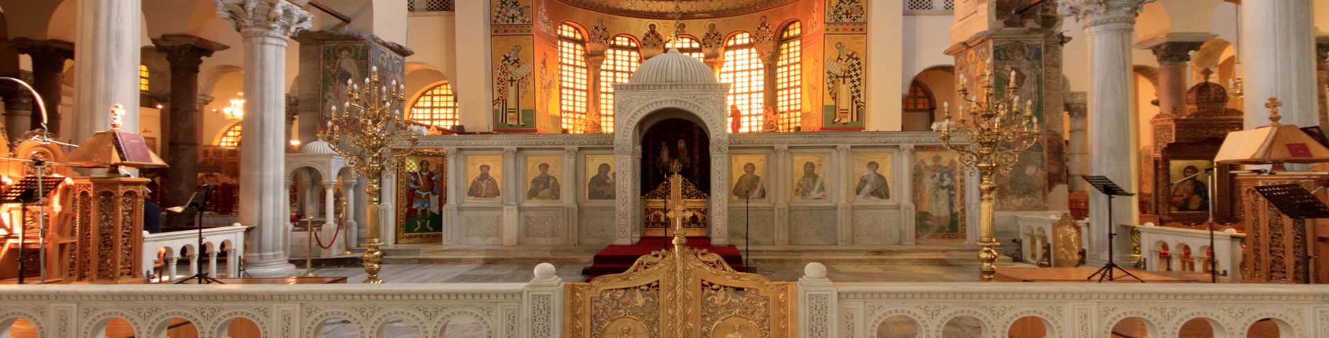 Religious artifacts fill a warmly-lit church.