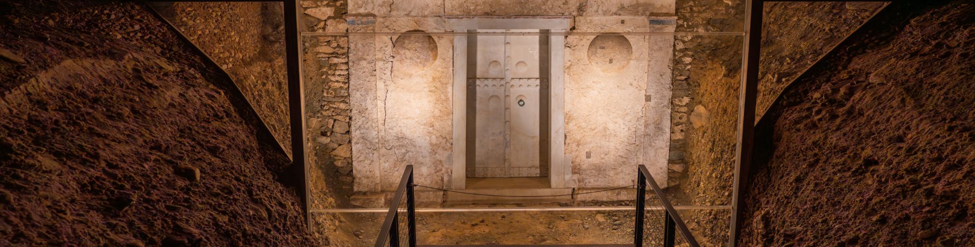 An ancient tomb entrance sits lit for onlookers.