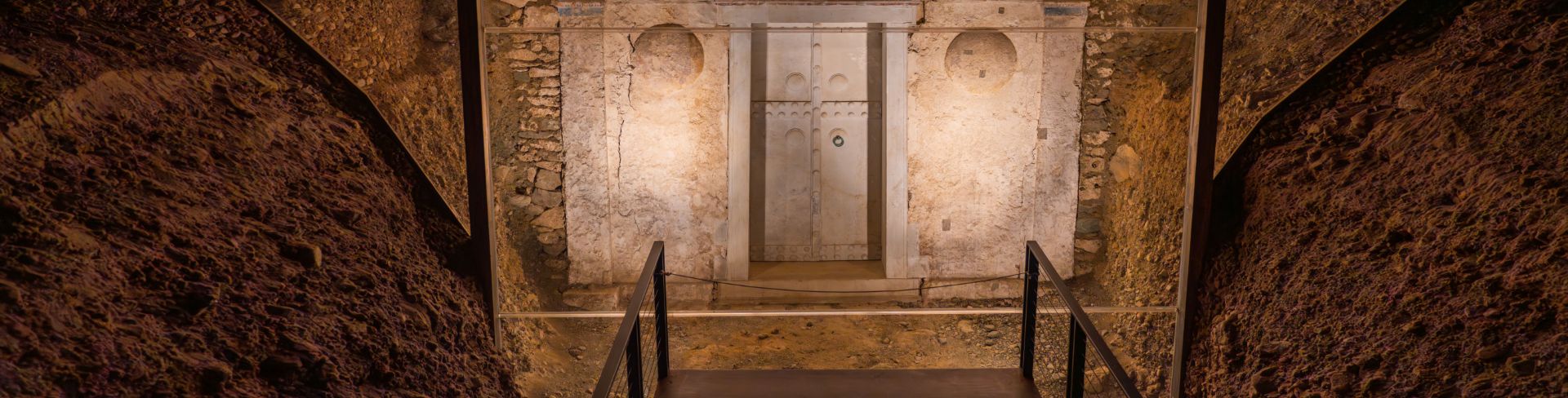 An ancient tomb entrance sits lit for onlookers.