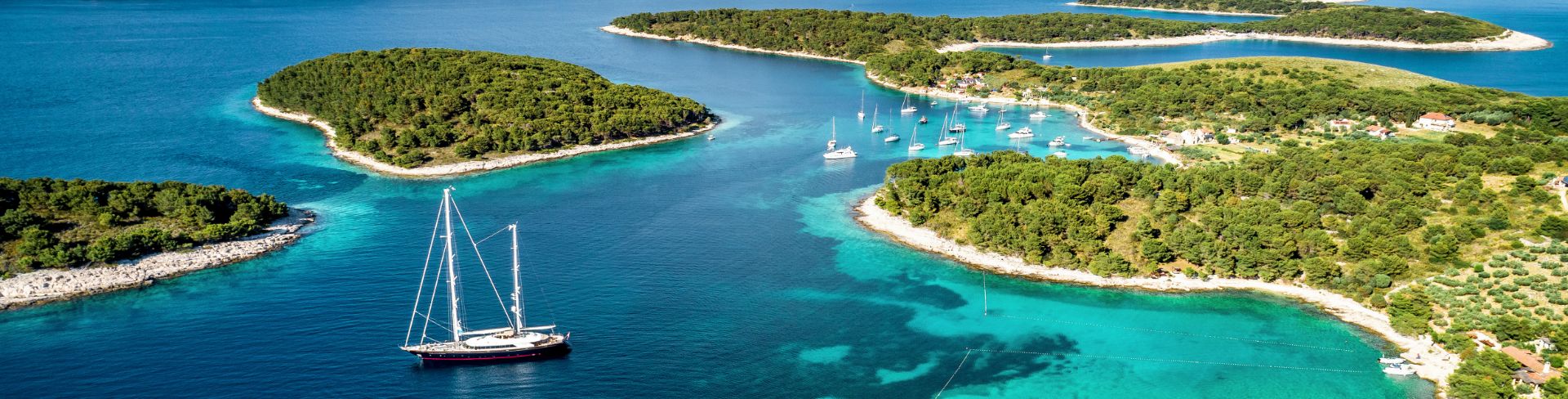 Small islands dot a deep blue waterway. 