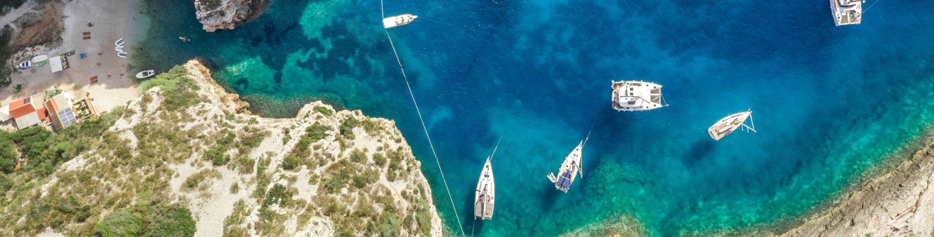 Small boats dot a multicolored waterway in Trogir, Croatia.