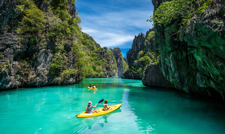 Kayakers in the pristine waters of Palawan Island in El Nido.