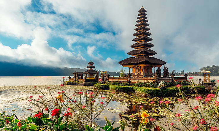 A temple sits surrounded by calm waters.