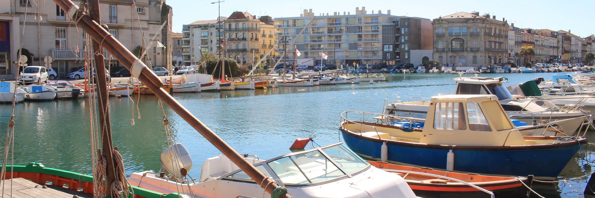 Small boats line a waterway in Sète, France