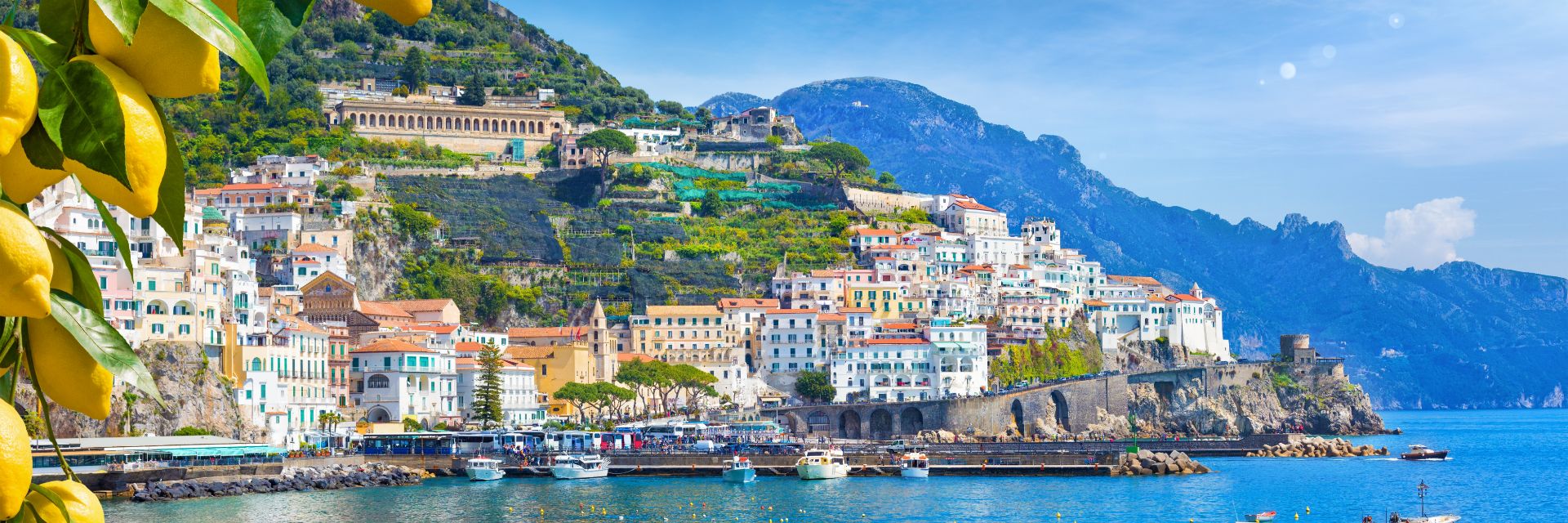 Buildings line a hillside overlooking the water.