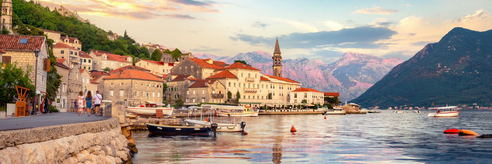 A waterway runs through a small city without mountains on the opposite side.