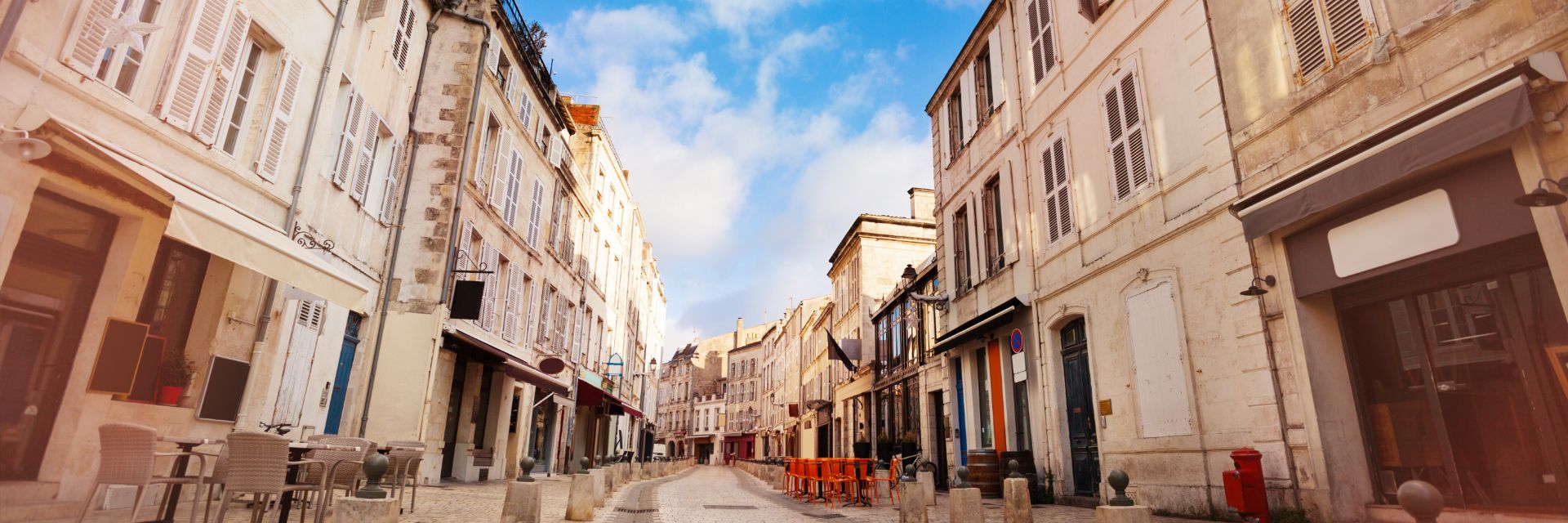 Buildings line a stone street.