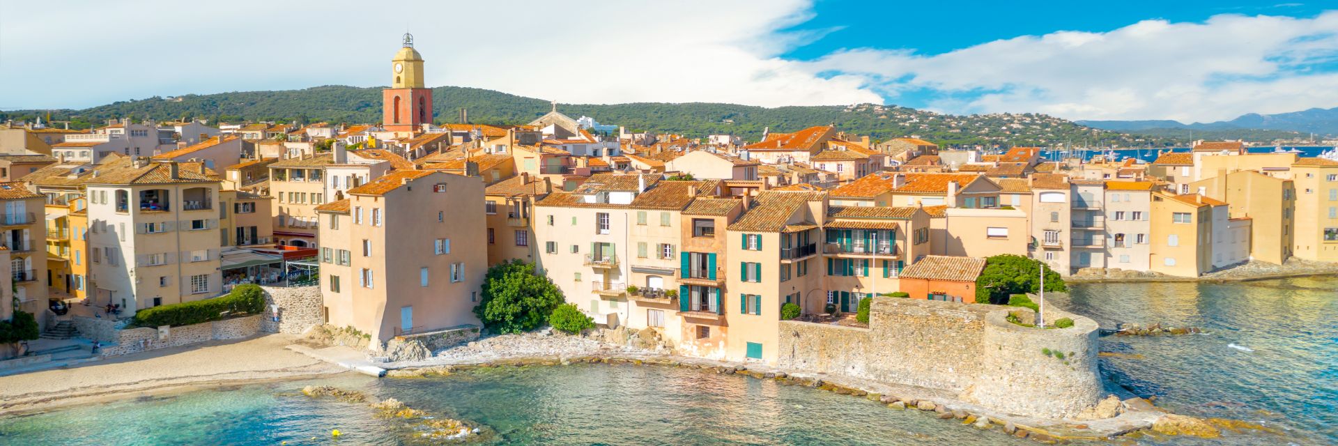 Stone buildings sit waterfront.