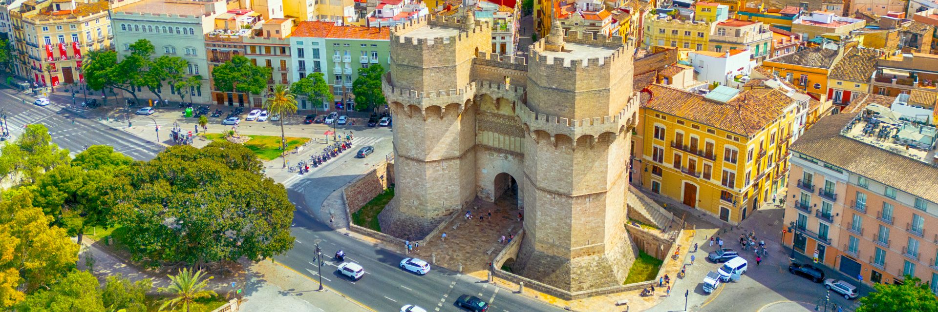 The sun shines down on buildings filling a town.