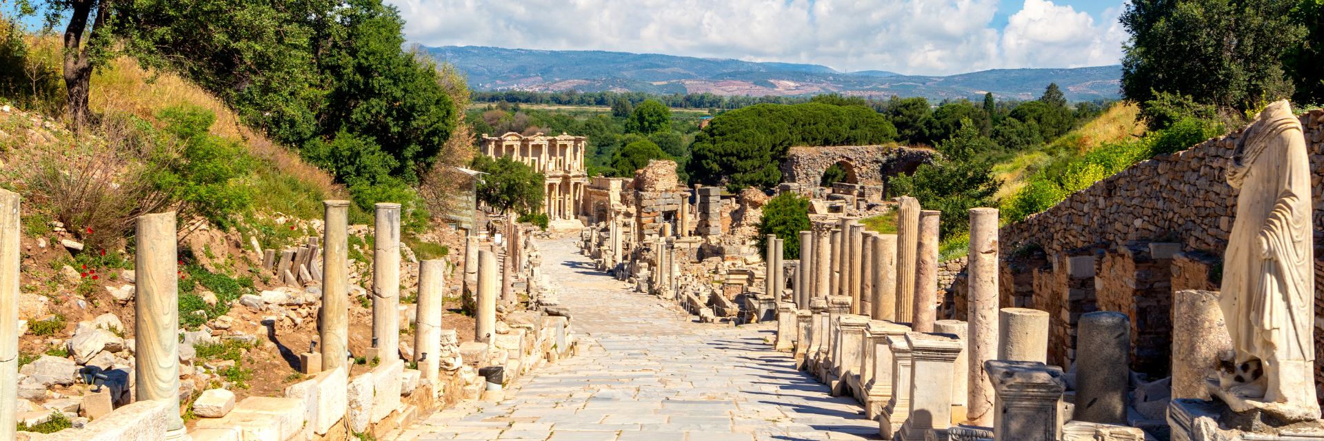Statues line an old stone walkway.