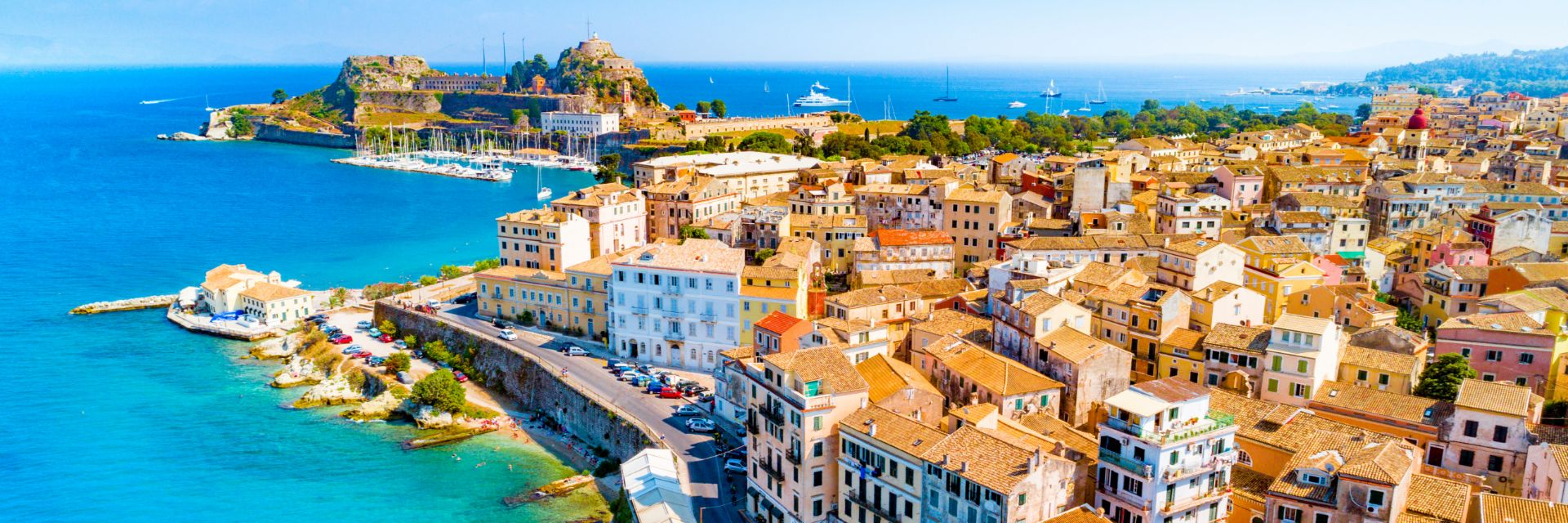 Buildings line a bright blue waterway.
