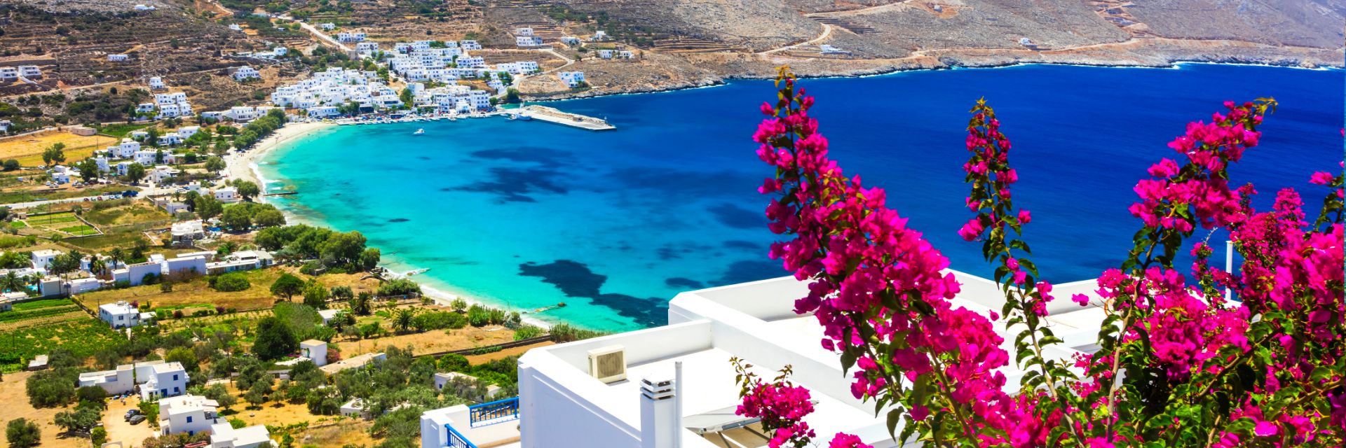 Bright blue waters meet a lush coastline.