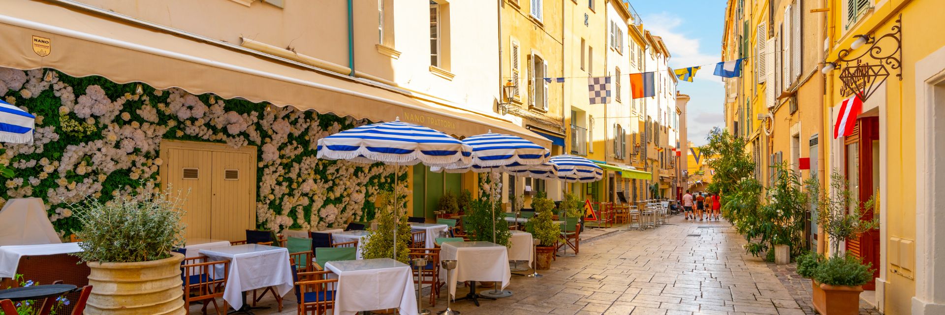 Dining tables line a stone walkway.
