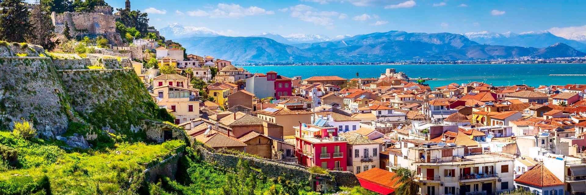 Light blue waters meet a coastline filled with terracotta rooftops.