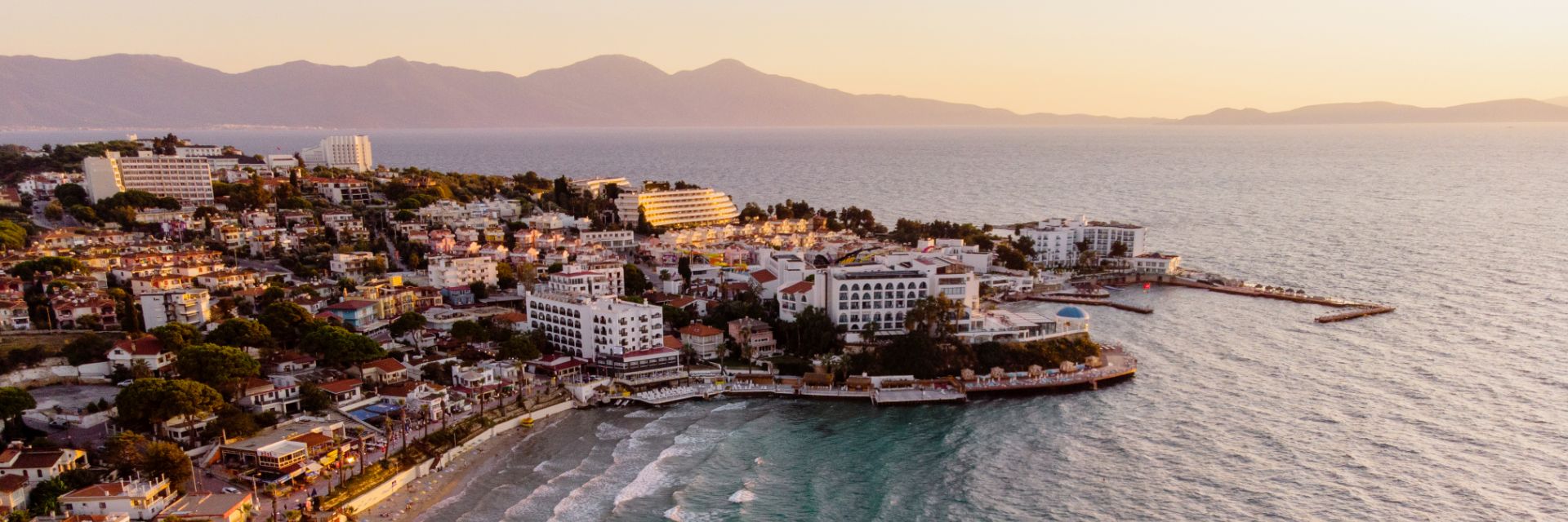 Dark blue waters meet a building covered peninsula