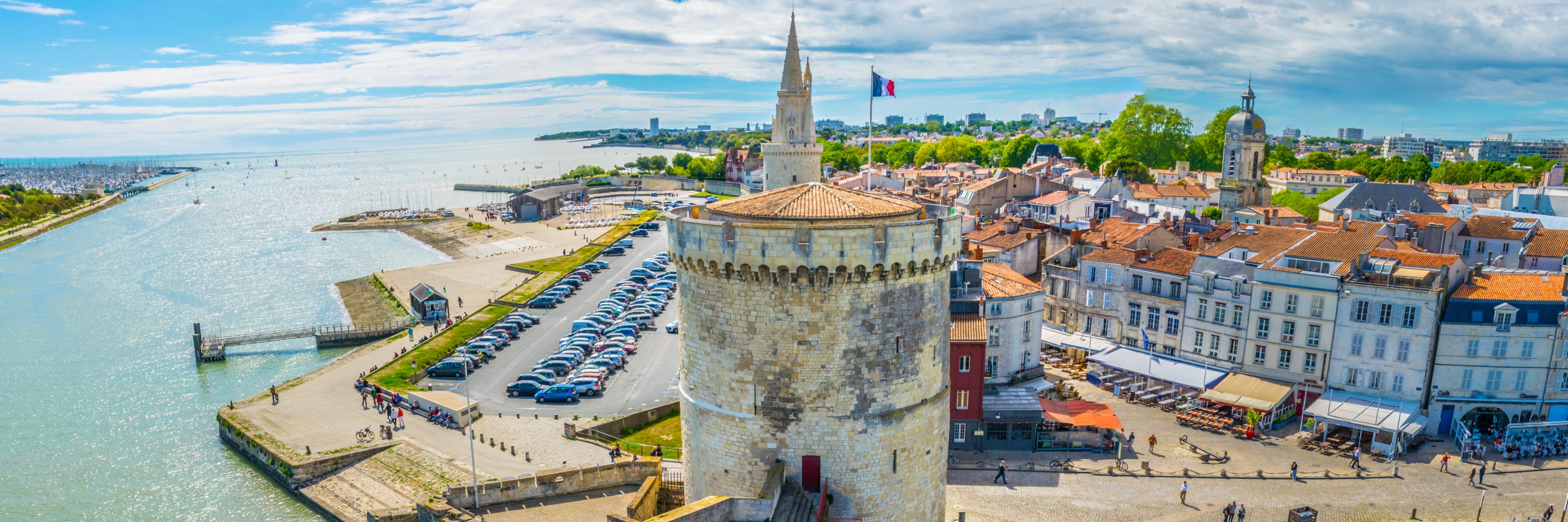 A waterway runs alongside buildings in La Rochelle, France.