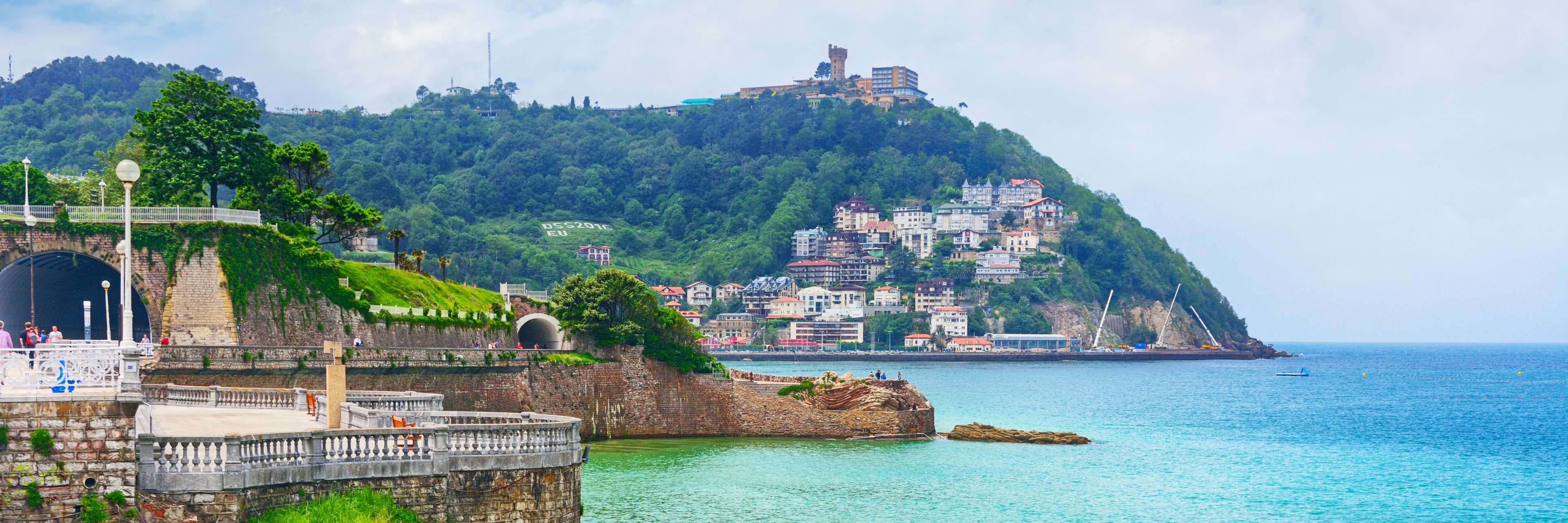 Bright blue waters meet the coastline in San Sebastián, Spain