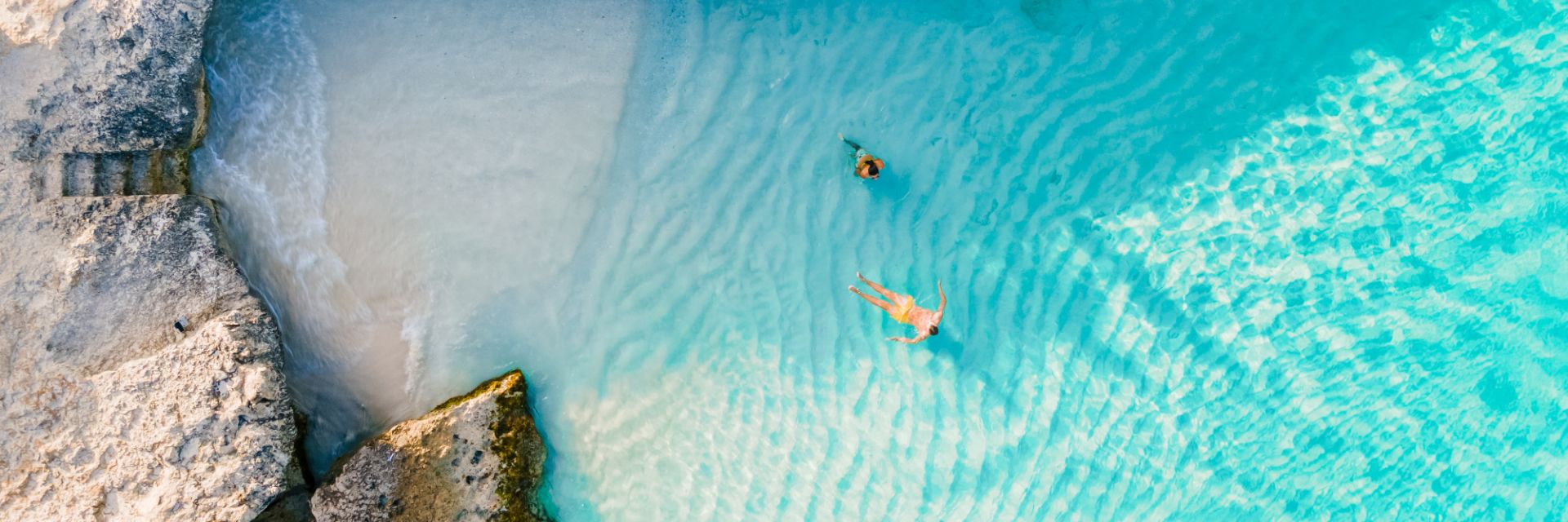 Beach with clear water and large rocks