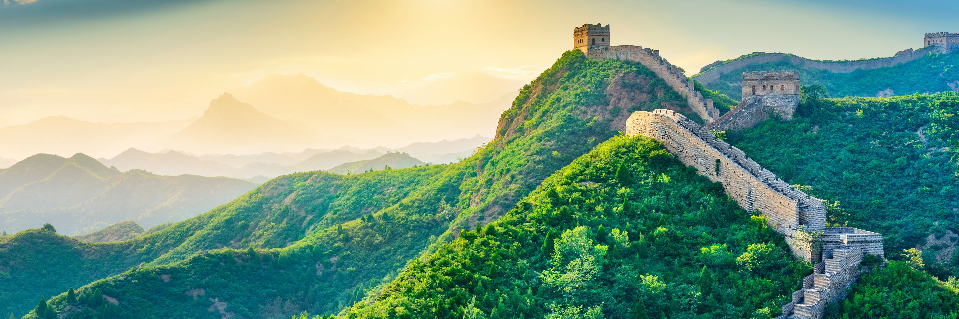 The sun shines down on the Great Wall of China.