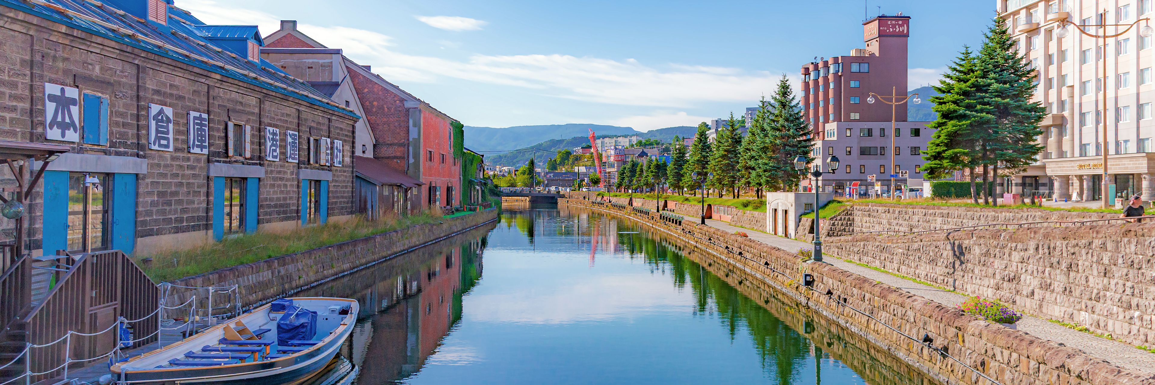 Buildings line a narrow waterway.