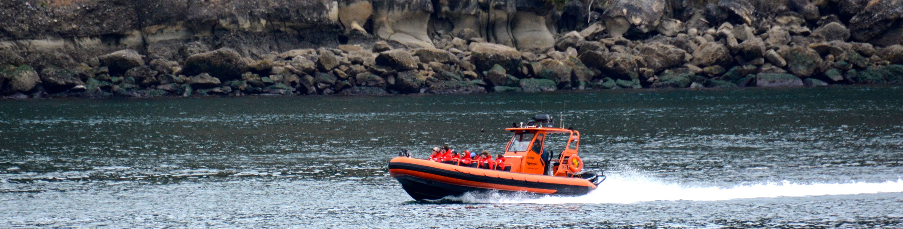 A small boat cruises across choppy waters.