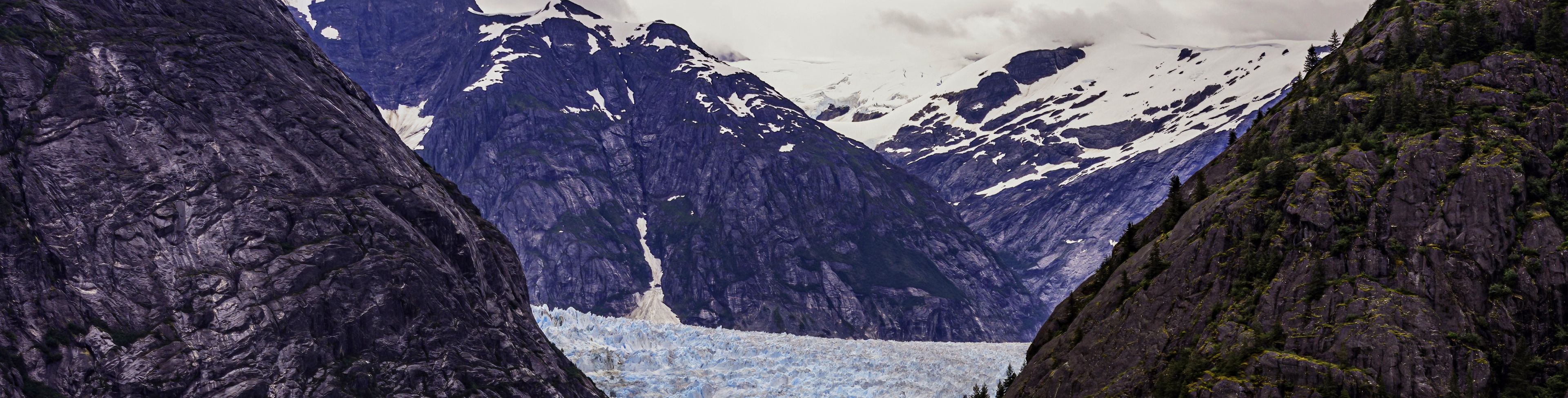 A small ice sheet floats through deep blue ocean waters.