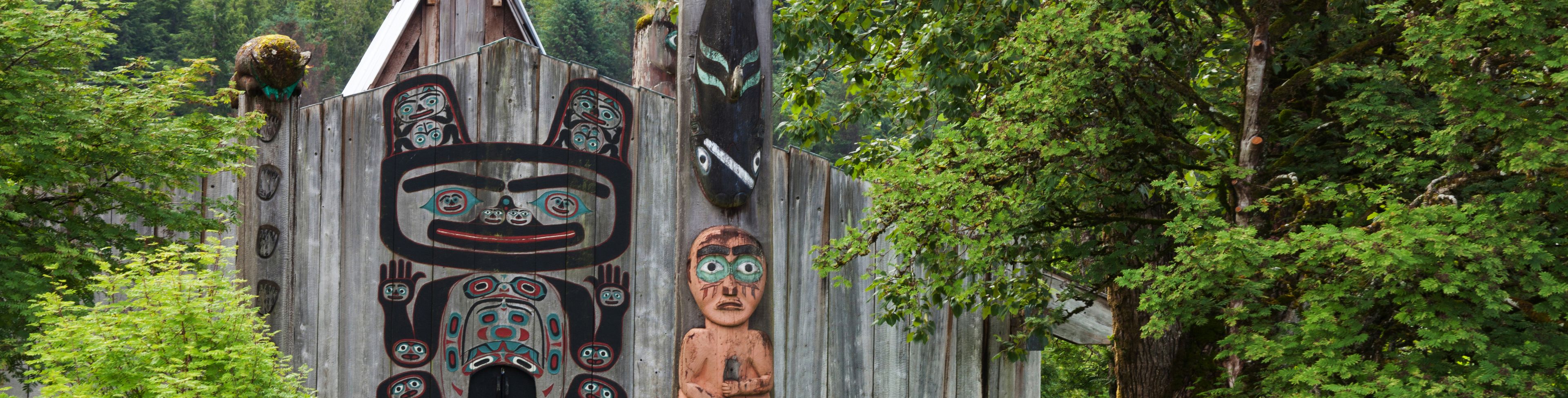 A totem sits in a forested area.