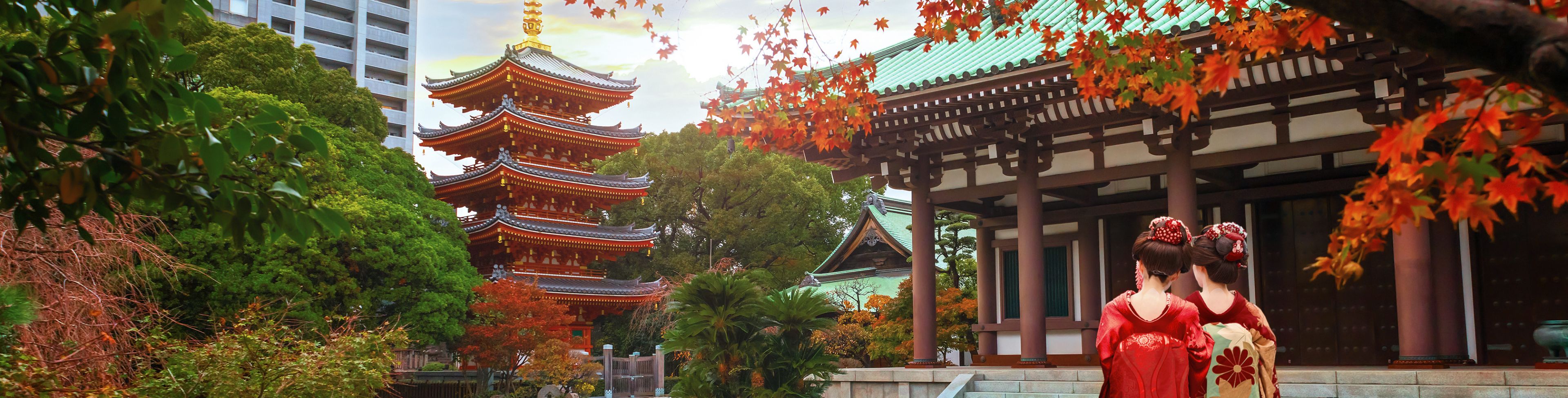 Two young girls walking between temples. 