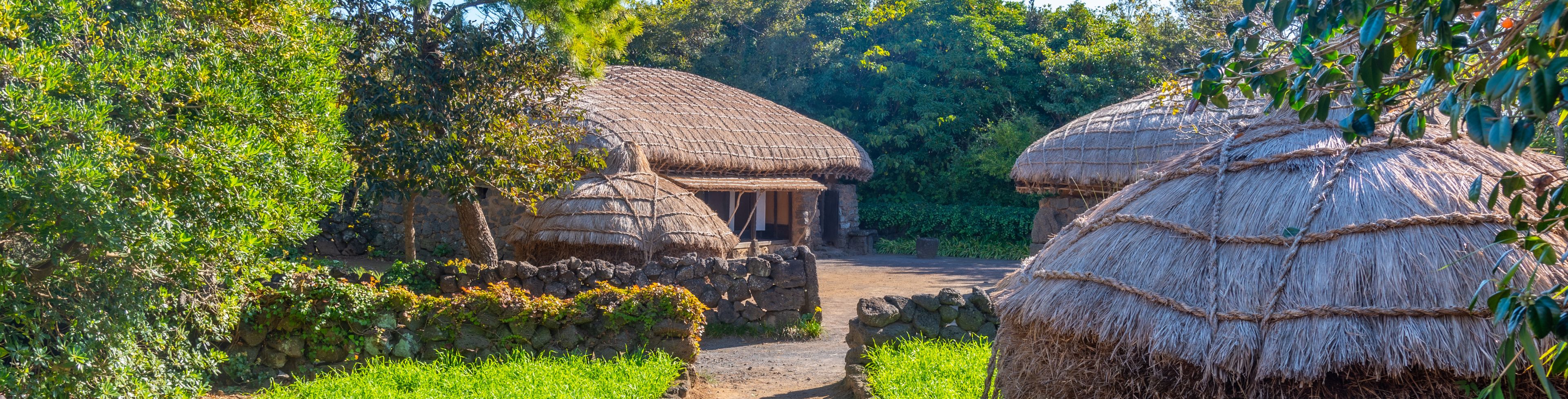 Three huts cluttered together in a village. 