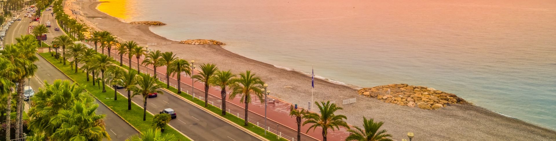 Street that curves with the beach line and ocean at sunrise. 