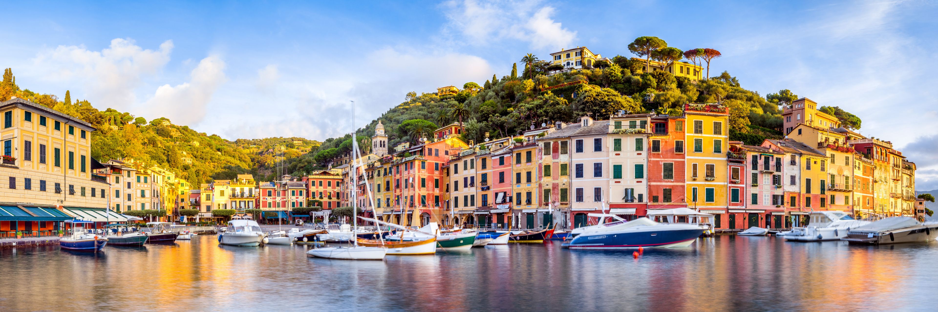 Colorful buildings line a calm waterway in Portofino, Italy.