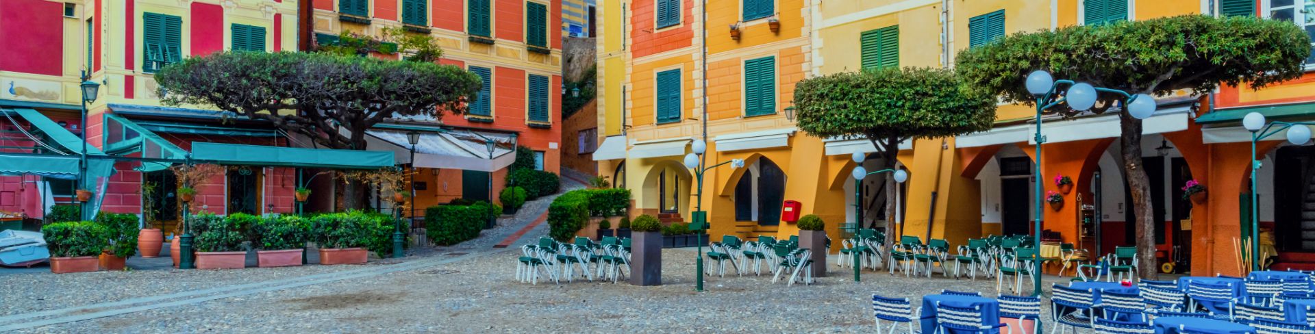 Empty village square with colorful buildings surrounding it. 