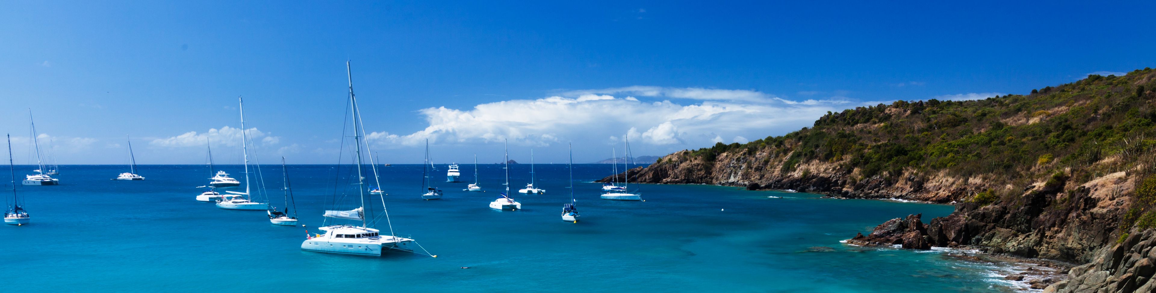 Boats anchored along shore. 
