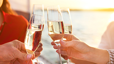 Three people toasting with champagne glasses together. 