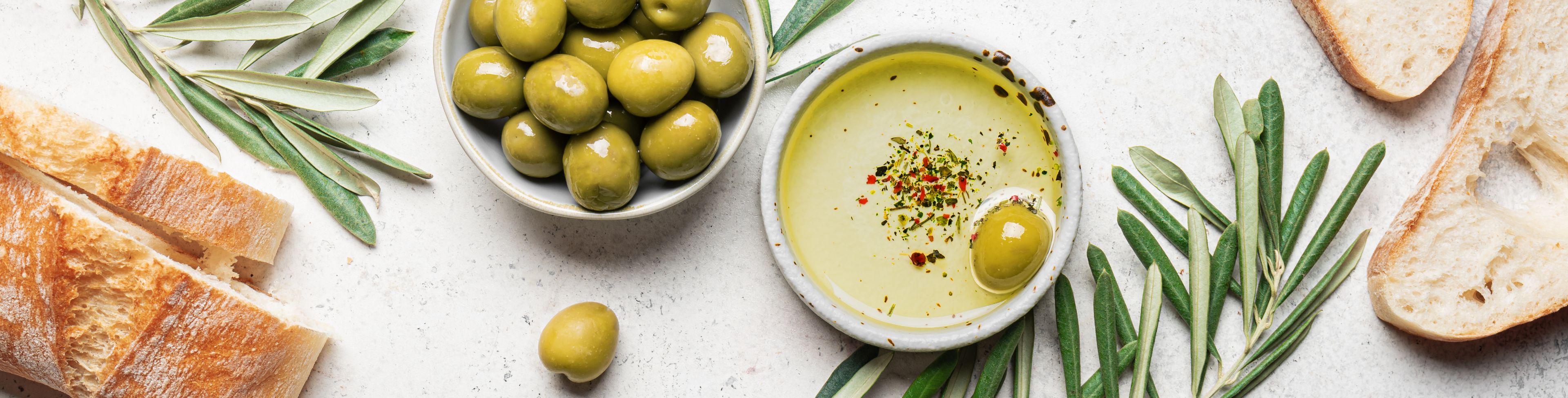 Fruit and soup in separate bowls on a table. 