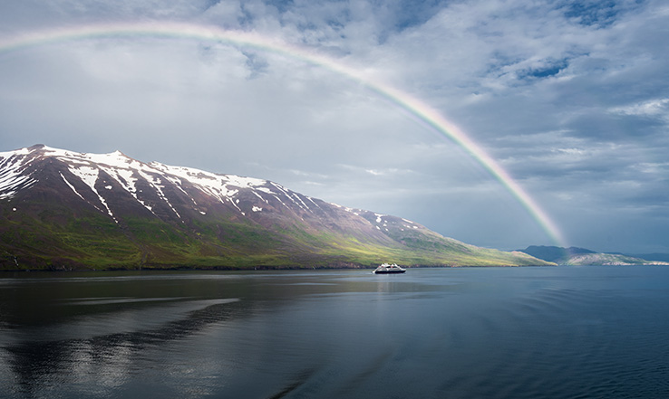 A rainbow in the sky over Akureyri, Iceland.
