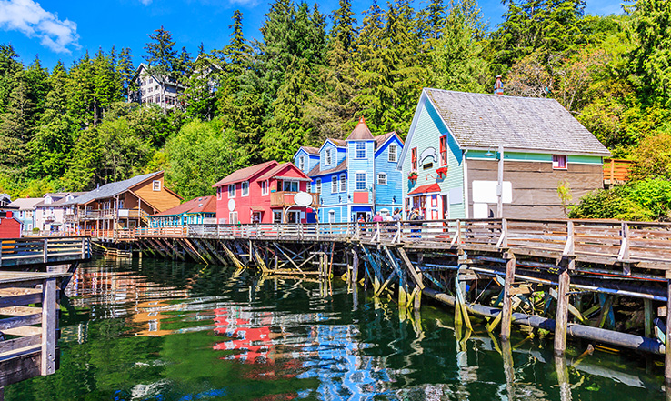 Houses with a dock in front of them, above the water. 