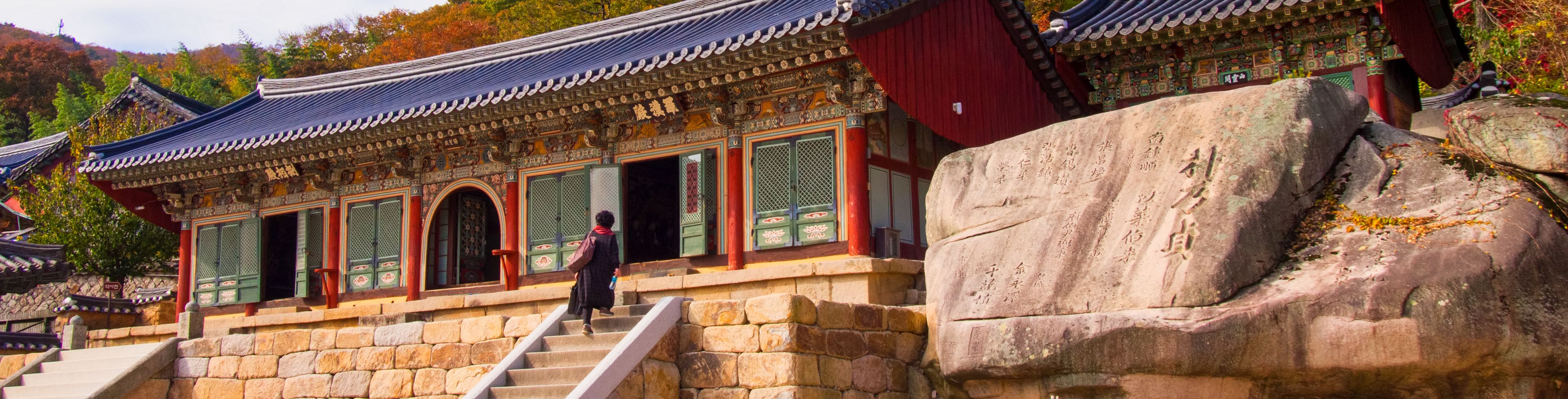 Person walking into the temple building. 