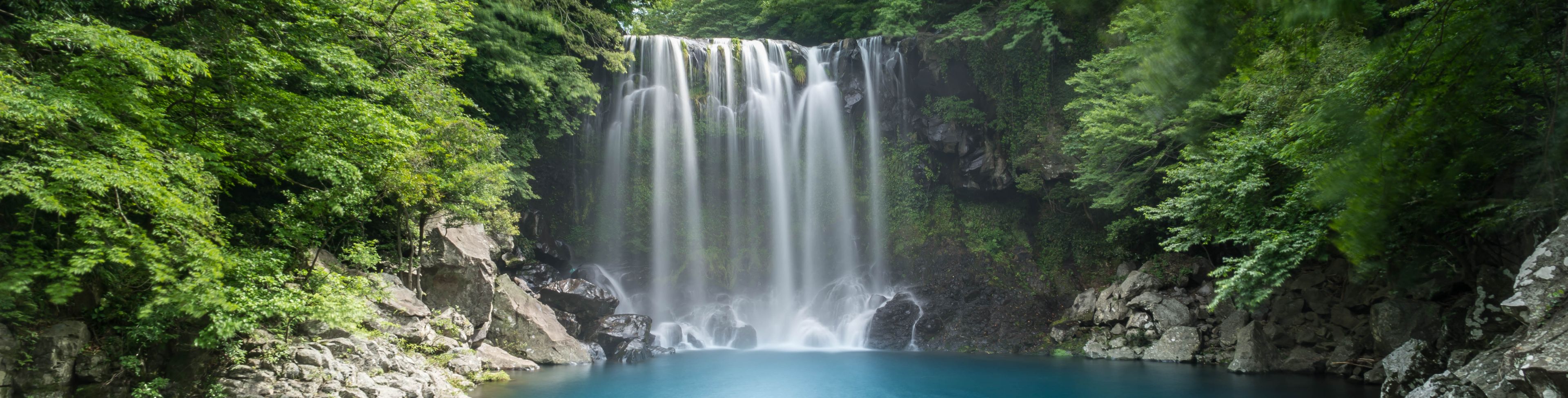 Waterfall into a small area of water. 