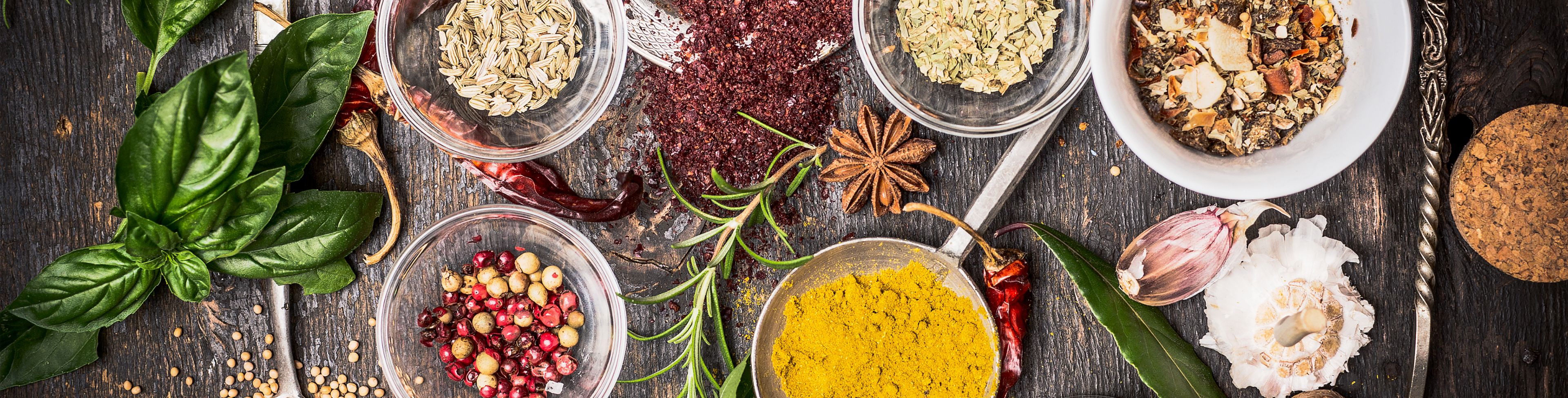 Plates and bowls of food and spices. 
