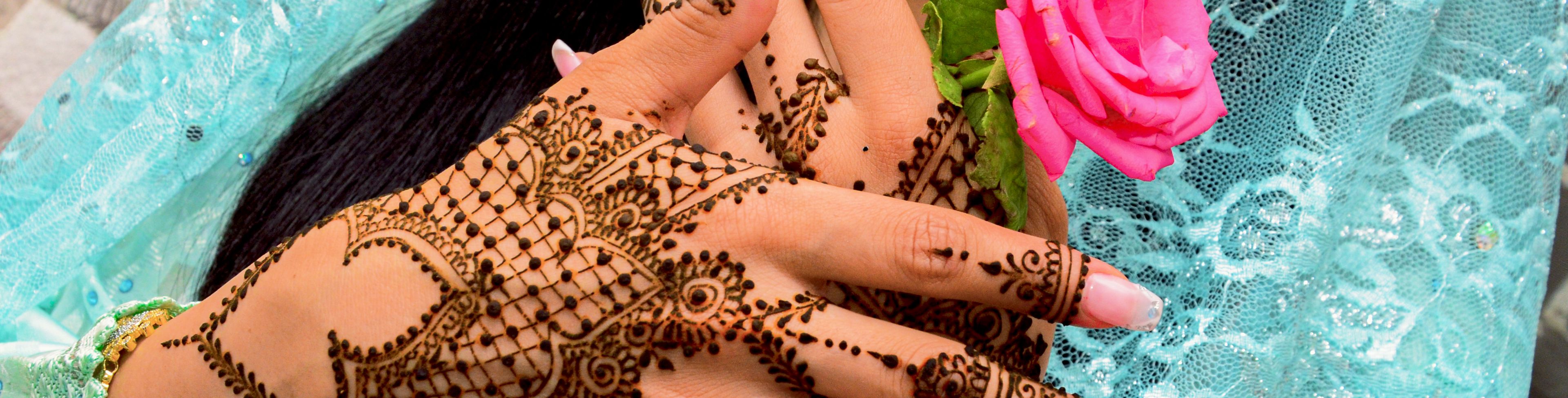 Woman wearing traditional garments and wearing henna on her hands. 