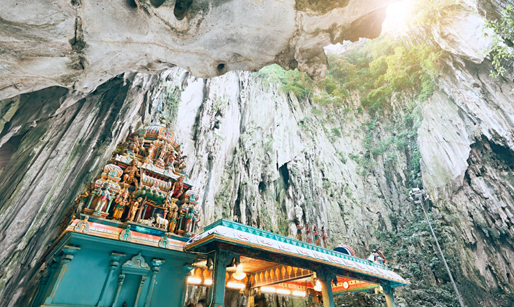 Temple at the bottom of a cliffside. 