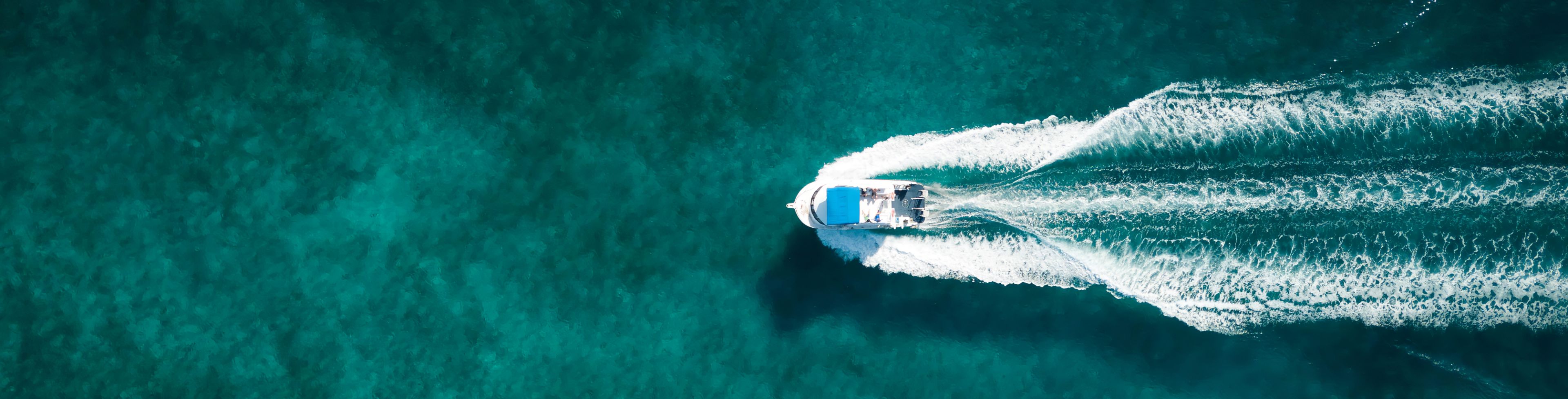 Aerial view of a speed boat boating in the ocean. 