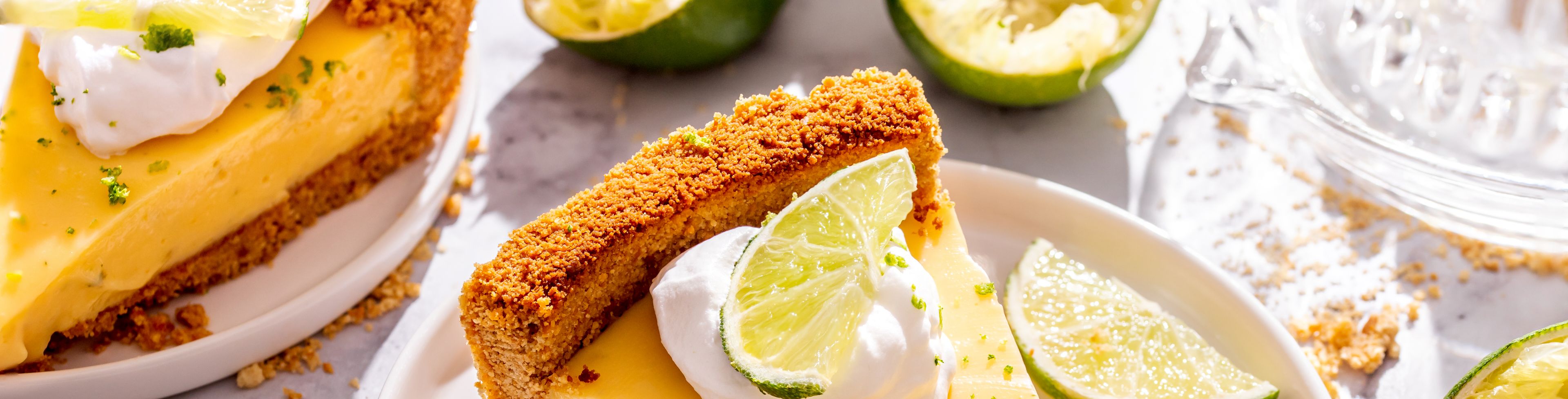 Plate of pie on a table surrounded by other food. 