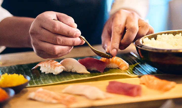Chef preparing food on a tray and table. 