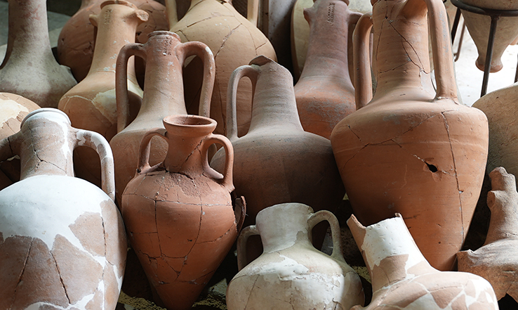 Many different color and sized clay jugs.