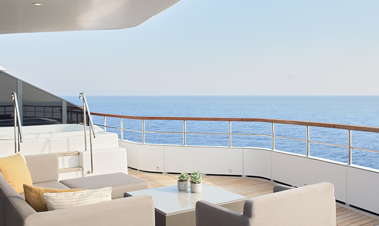 Outdoor furniture on yacht deck overlooking the ocean.. 